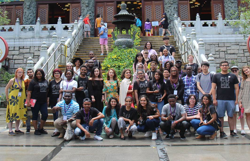 A group pose in front of temple steps