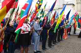Flags of the Commonwealth being held by a diverse group